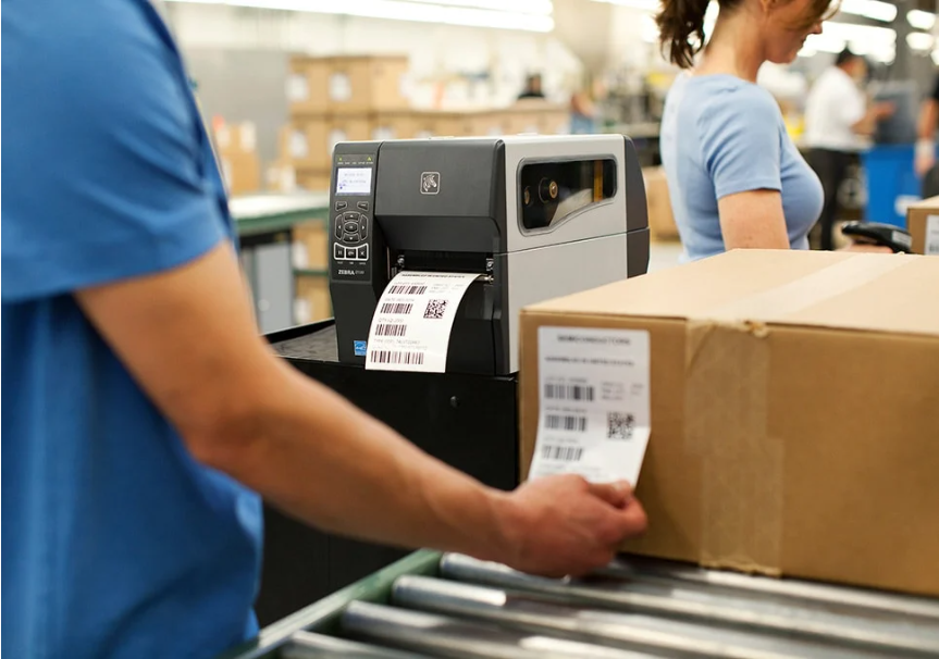 Desktop thermal barcode label printer on workstation